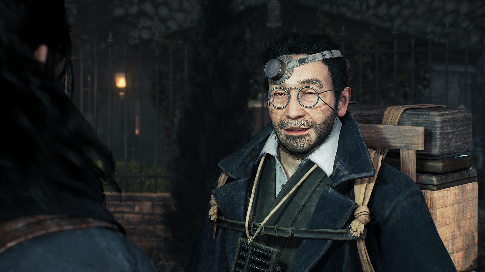 A close up of Igashichi. The character wears glasses and an overcoat. He has multiple cases of varying sizes tightened together and strapped to his back.