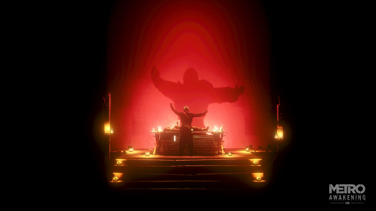 A rickety wooden stairwell leads up to a stage, on which stands a figure, arms outstretched. Their shadow is cast huge against the wall behind them by multiple candles that turn the wall red. In front of the figure is a person prone on a table.