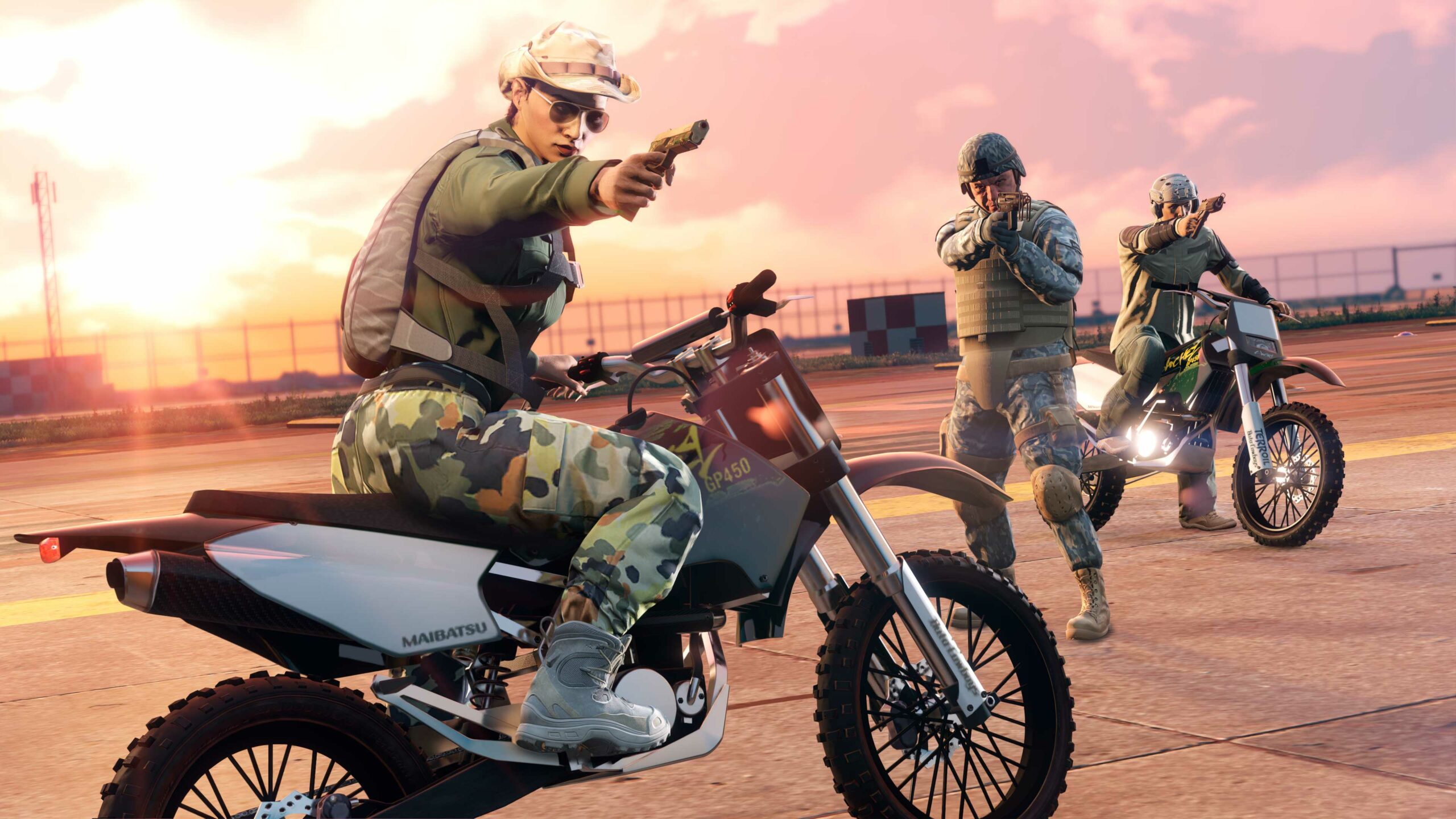 Three GTA Online characters wearing military gear aim weapons off-frame as two are stationary on Sanchez off-road motorbikes.