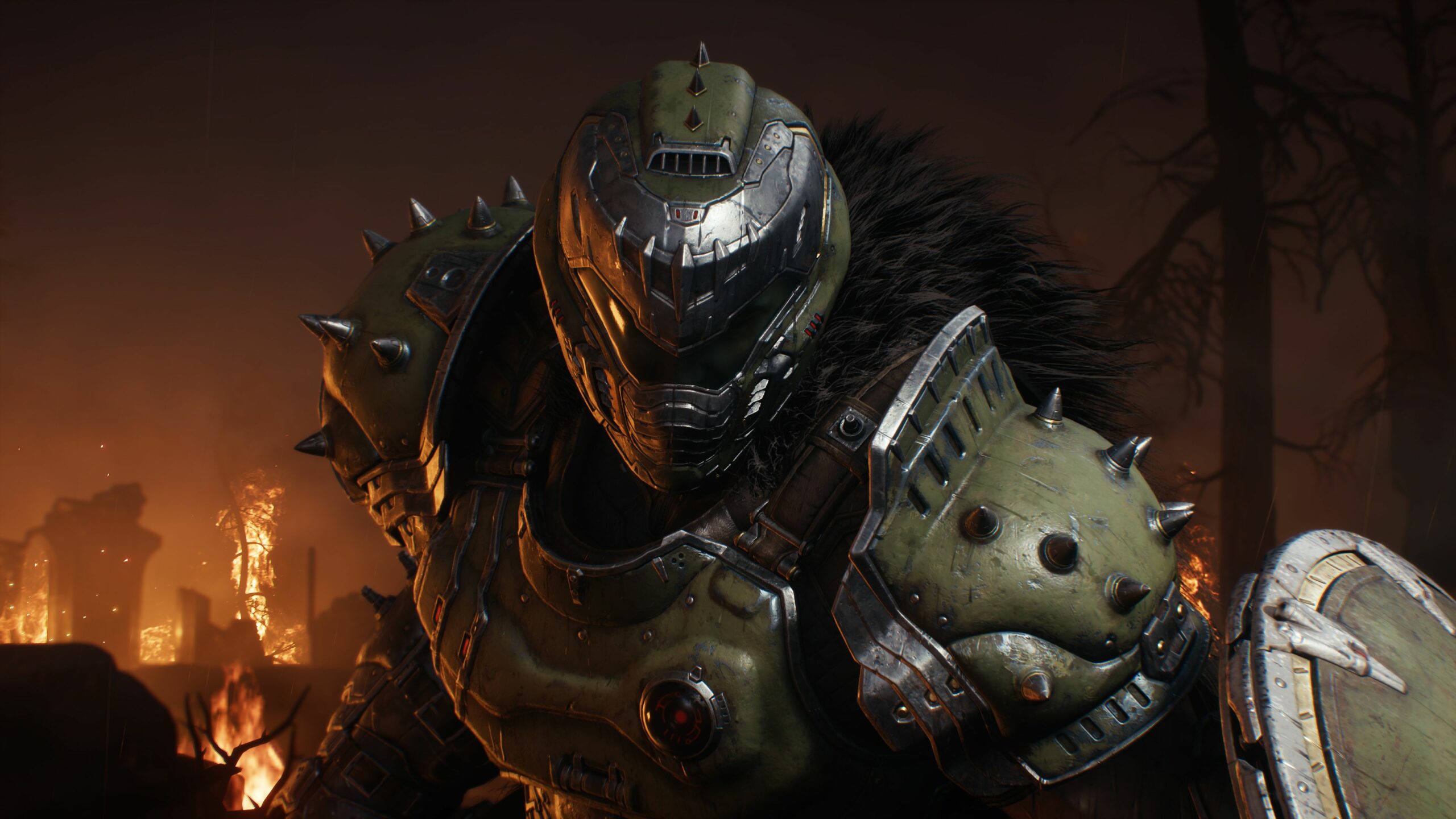 The DOOM Slayer stares down the viewer, lit by flames in the background.